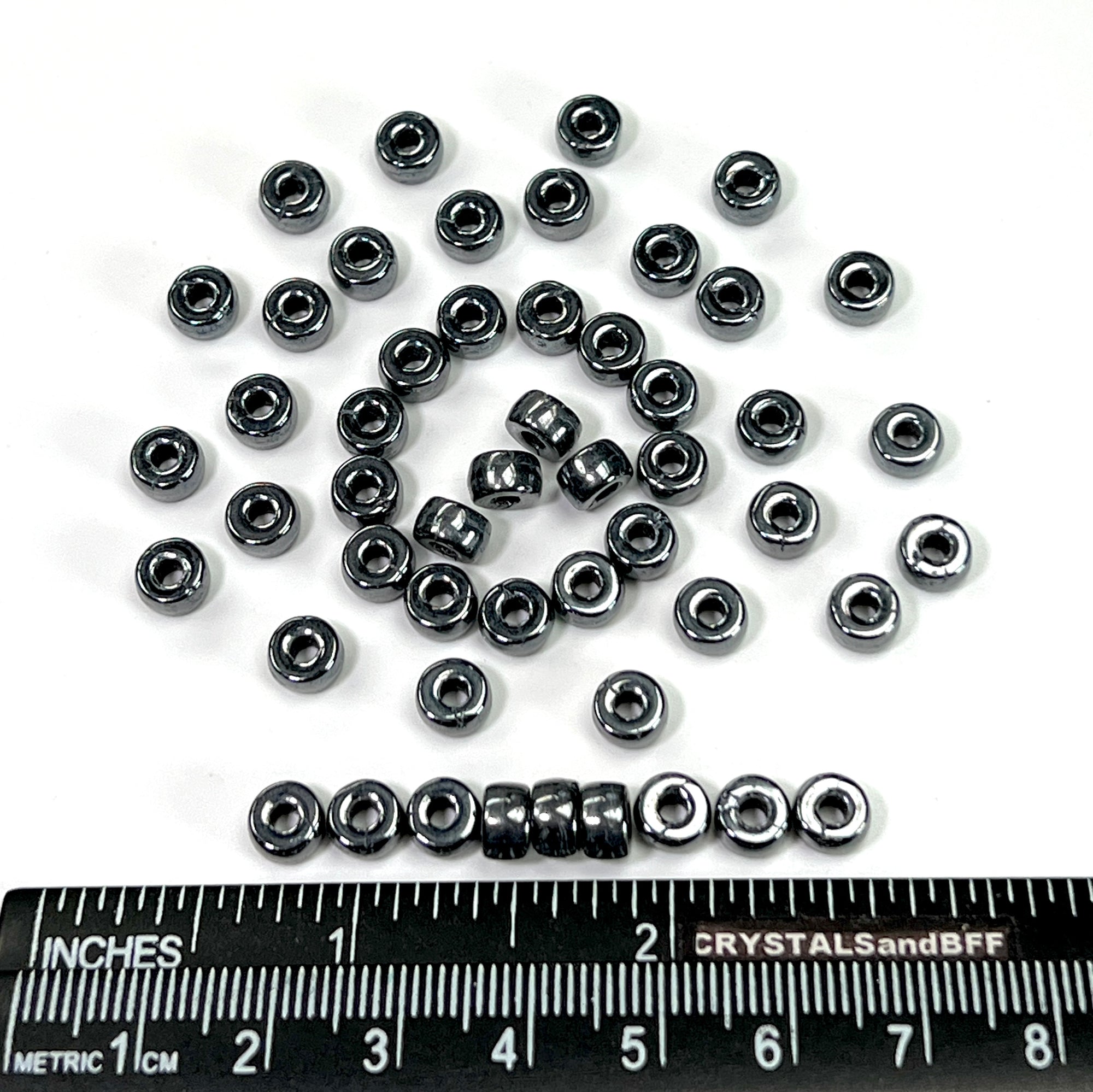Czech Glass Druk Large Hole Roller Beads in size 6mm Jet Hematite coated 50pcs J083