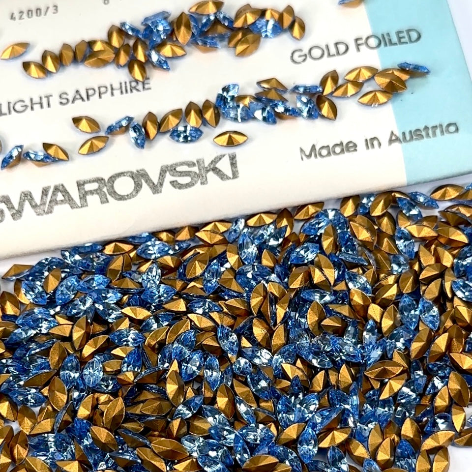 Swarovski Art.# 4200/3 - Light Sapphire blue Gold Foiled Pressed Navette Pointed Back Stones in size 8x4mm 720pcs SW079