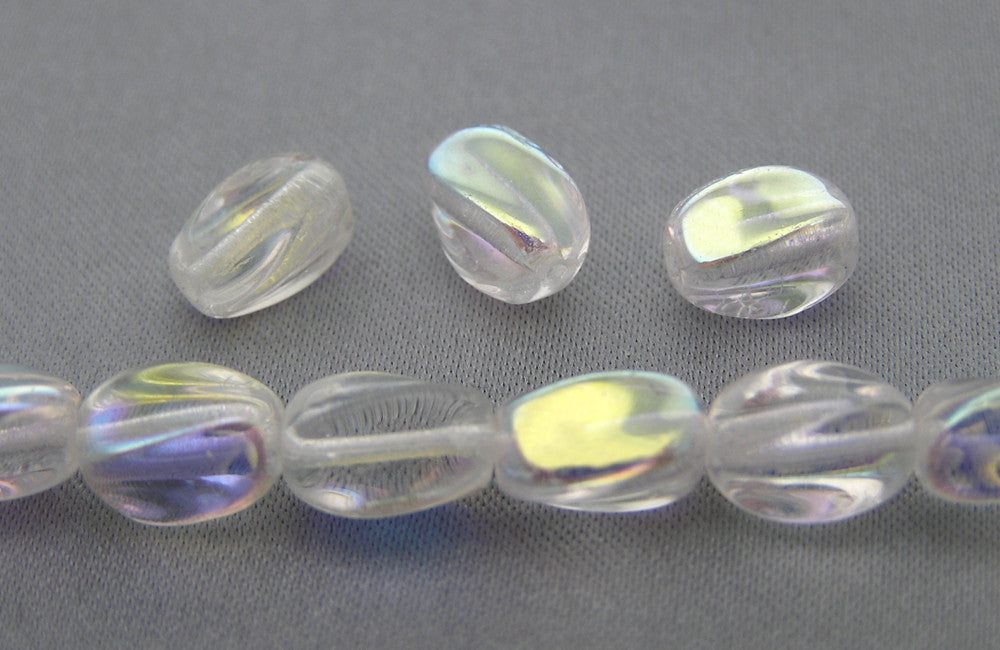 23 Czech Glass Druk Beads 9x7mm Crystal AB twisted oval, pressed, clear AB, P203